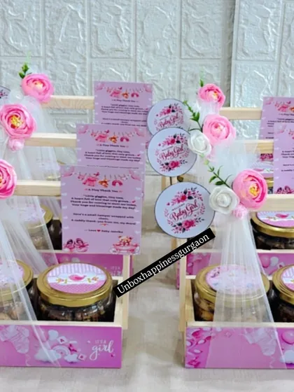 A display of multiple pink-themed announcement baskets, perfect for distributing to guests at a hospital or a welcome-home gathering.