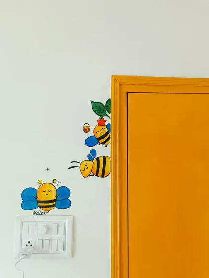 Art doesn't have to be huge to make an impact. I love adding small, playful doodles like these cute bees around light switches and door frames to bring a little bit of unexpected joy to a room.