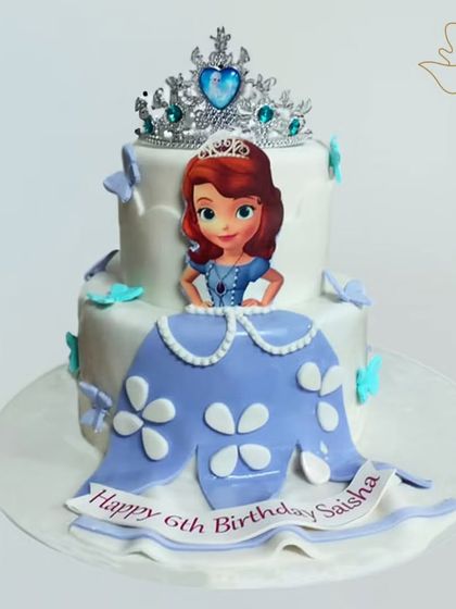 A grand two-tier Princess Sofia cake, crowned with a sparkling tiara. This royal creation is perfect for a little princess's birthday, complete with edible butterflies and a personalized banner.