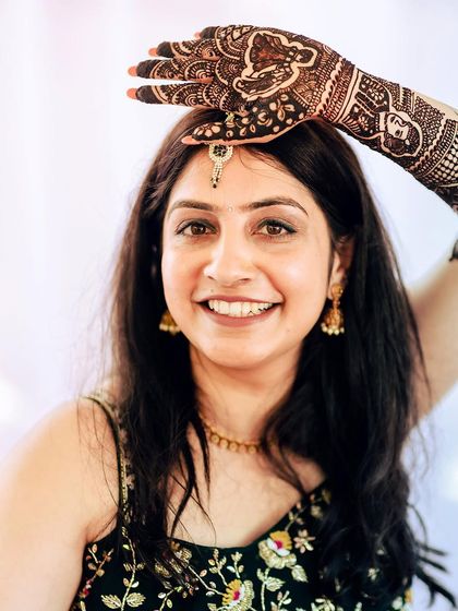 A lovely portrait of the bride-to-be showcasing her intricate Mehendi design.