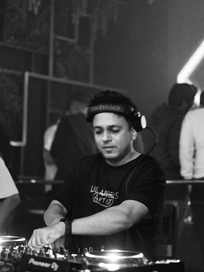 A classic DJ pose, mixing tracks with my headphones on.