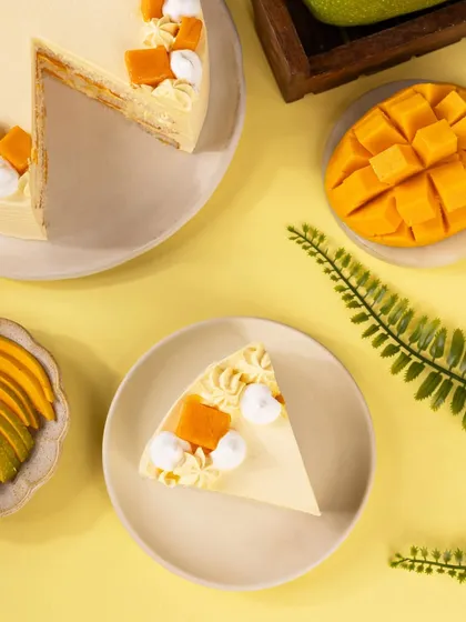 A top-down "flatlay" view of the mango cake slice. This perspective offers a graphic and modern look at the dessert, great for social media feeds.