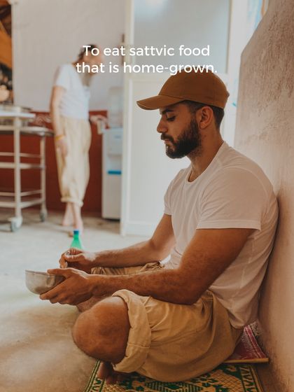 A student enjoys a simple, home-grown sattvic meal. Eating mindfully is part of the yogic lifestyle, nourishing the body and calming the mind.