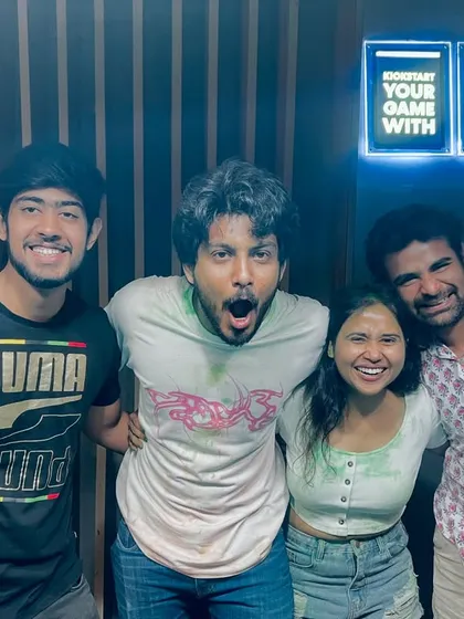 A group of friends celebrating Holi with us, their faces full of joy and excitement after a round of festive karaoke.