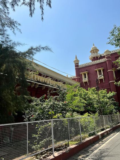 The beautiful red building of the High Court in Lucknow, surrounded by lush greenery. The architecture and history of our courts are a constant source of inspiration.