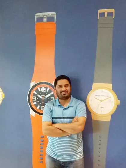 Here I am with a finished project for a watch company's office. I painted larger-than-life versions of their products directly onto the wall, creating a bold, branded statement. This type of custom corporate art reinforces brand identity and makes a memorable impression on clients and employees.