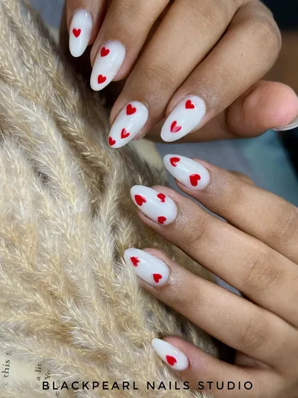 A playful and romantic set featuring a milky white base with delicate, hand-painted red hearts. This design is perfect for Valentine's Day or for anyone who loves a cute and chic look.