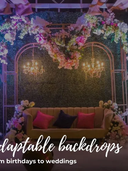 Our backdrops are adaptable for any event, from birthdays to weddings. This one features a heart-shaped floral design on a green wall.