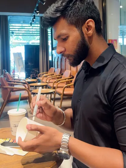 Another shot of me working on the custom coffee cup art. This project was a fun challenge and a great conversation starter.