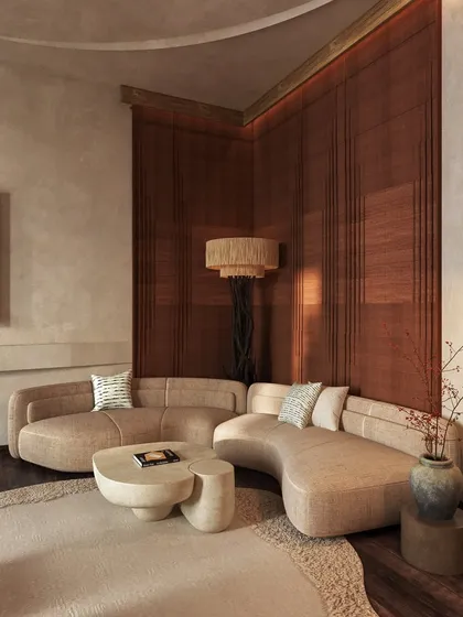 Another view of the seating nook, showing the interplay of the curved sofa and the organic-shaped coffee table. The textures and tones are earthy, elemental, and serene.