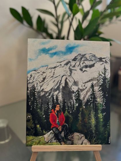 The finished mountain landscape painting displayed on an easel, a perfect piece of home decor that holds a personal memory.