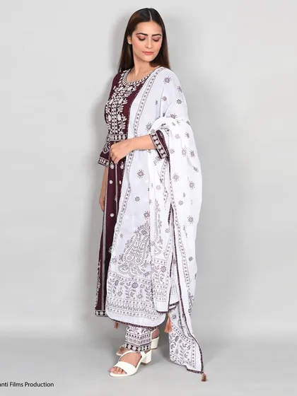 We capture the fine details of ethnic wear, as seen in this side-profile shot of a model in an embroidered kurta set. The focus is on the fabric, pattern, and overall silhouette.