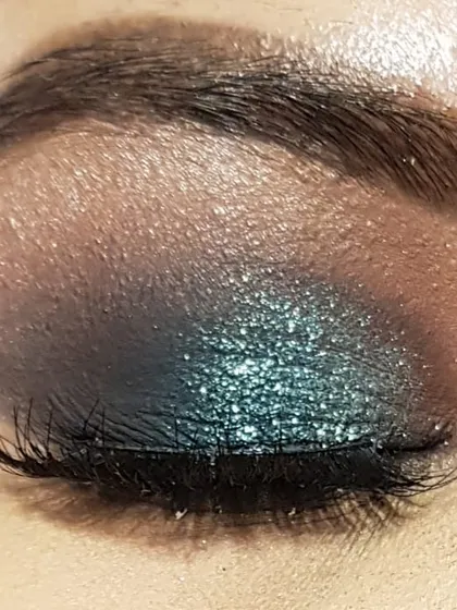 Here is the same teal glitter eye makeup with my eye closed. You can see the smooth blending from the brown transition shade to the deep teal and the pop of glitter on the lid.