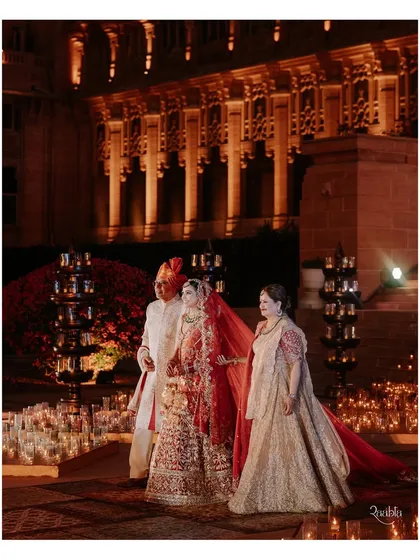 A bride makes her grand entrance with her parents at the Umaid Bhawan Palace. We coordinate these deeply emotional moments, ensuring the lighting, music, and pathway are perfect.