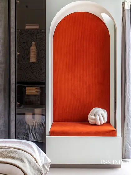 A child's room can be both playful and stylish. This cozy reading nook, with its vibrant orange velvet and arched frame, creates a special spot for imagination to flourish. It’s a perfect example of how to add character that feels both fun and timeless.