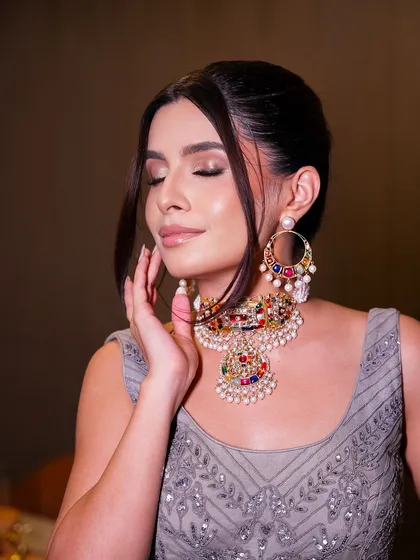 A soft glam evening look featuring a beautiful smoky eye with purple and brown tones. The skin is kept dewy and fresh, balancing the drama of the eyes.