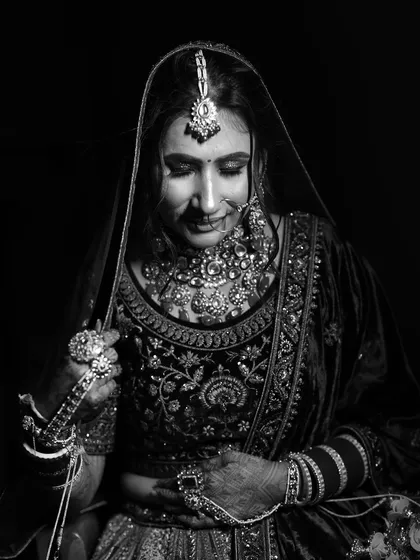 Another classic black and white shot, focusing on the bride's beautiful smile and the delicate details of her wedding attire.