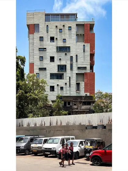 The award-winning J-House seen from the street level, where it stands in contrast to its surroundings. The design re-establishes a relationship with the street by lifting the mass of the building, creating a more human-scaled presence.