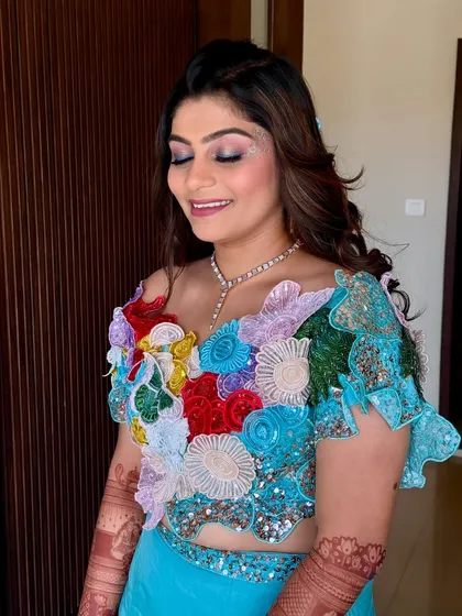 A close-up of the carnival makeup. I used soft pink and shimmer on the eyes with a touch of sparkle on the cheekbones to match the whimsical and colorful floral applique on her blouse.
