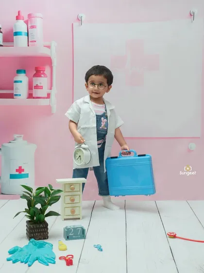 This little doctor is making his rounds. We create detailed, immersive sets like this mini-clinic to make our themed photoshoots feel authentic and special.