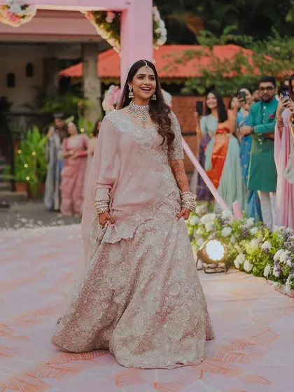 Her grand entrance. Walking down the aisle, her soft glam makeup looks radiant and effortless, making her the center of everyone's attention.