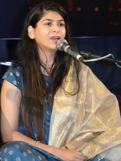 A close-up of a student vocalist during the Raag Miya Malhar performance, showcasing her expressive singing.