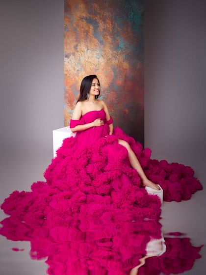 This vibrant magenta gown is pure joy and celebration. The reflection on the floor doubles the impact of the incredible color and texture of the ruffled skirt.