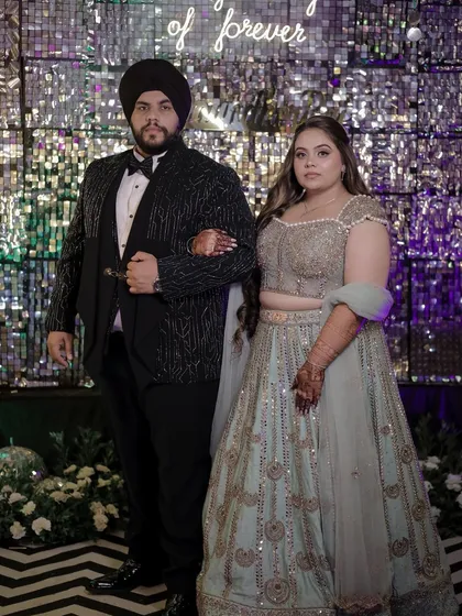 Another couple portrait where the bride's glamorous hairstyle stands out. The soft waves complement the glittering backdrop and her elegant lehenga.
