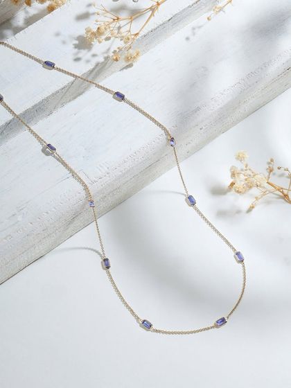 The Tanzanite Gold Chain, a simple yet luxurious piece featuring tanzanite stations along a fine chain. It's a piece that glows as uniquely as you do.