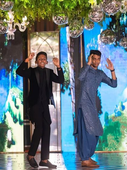 A cool shot of the brothers dancing for the couple. This captures the fun and camaraderie of a groomsmen performance.