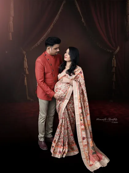 A traditional portrait celebrating heritage and love. The couple looks elegant in their ethnic wear, sharing a quiet moment of anticipation.