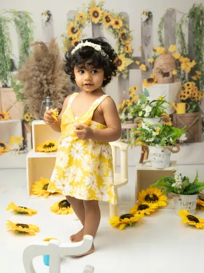 Exploring the set. This candid photo shows her standing and interacting with the props, capturing a milestone moment.