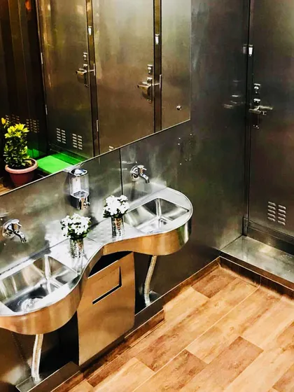 Quality is in the details. This interior view of a washroom facility features high-grade stainless steel fixtures and premium finishes, proving that container structures can achieve a high level of sophistication and durability.