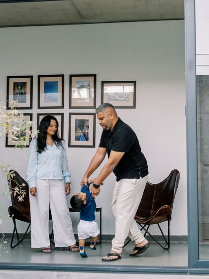 A family playing with their toddler in their modern, light-filled home. The architecture and the family's joy combine for a beautiful lifestyle shot.