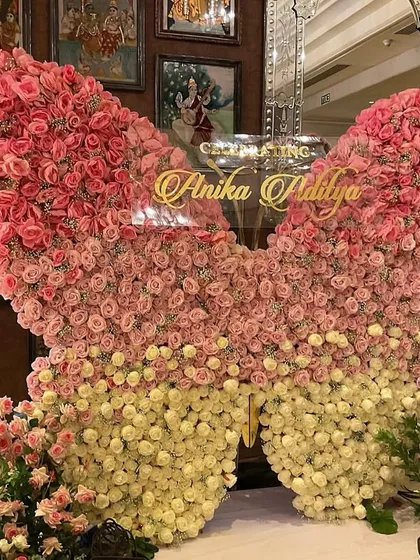 We crafted this breathtaking butterfly backdrop from hundreds of fresh pink and cream roses for a truly magical cradle ceremony. This statement piece creates a stunning focal point and a perfect photo opportunity, celebrating new life in the most beautiful way.