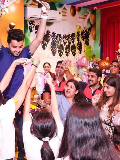 The whole party, kids and adults, joining in on the fun and games. I design my parties to be an inclusive experience for all guests.
