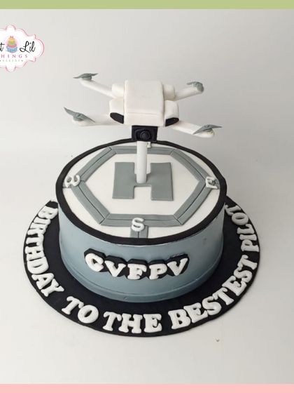 A cake for the "bestest pilot," this drone-themed creation features a detailed edible drone on a helipad.