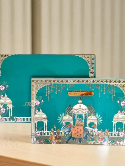 For a grand and traditional statement, I created this Pichwai-themed invitation. The rich teal and intricate artwork, featuring a royal procession, are printed on high-quality cardstock to announce your celebration with regal flair.