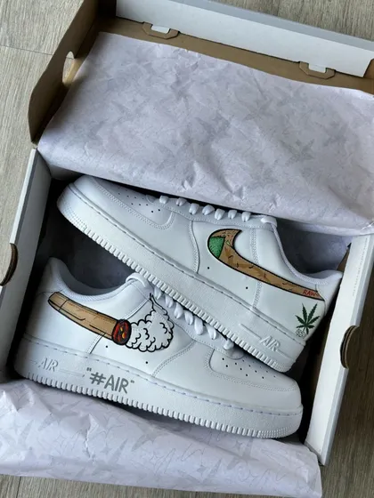 The RAW-themed custom sneakers displayed in their box.