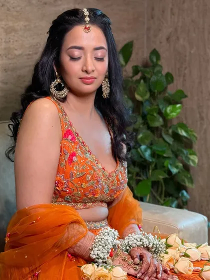 A serene moment. The makeup is flawless, and the floral jewellery adds a traditional yet fresh touch to the overall look.