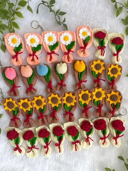 A whole garden of my mini crochet bouquet keychains. These adorable handmade accessories come in a variety of flowers like daisies, tulips, sunflowers, and roses.