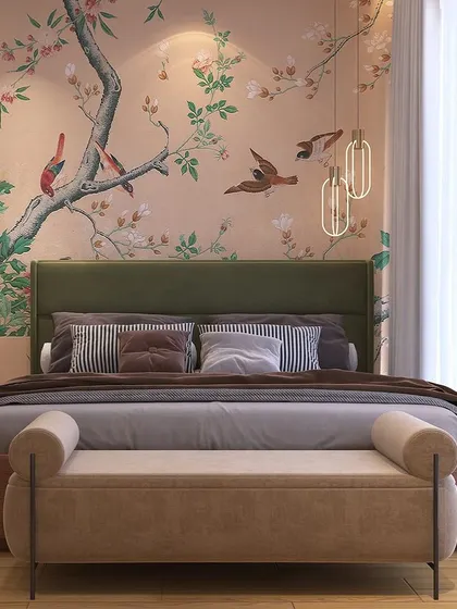 A minimalist bedroom design featuring a beautiful custom wallpaper with a bird and branch motif. The simple green headboard and neutral-toned bench create a peaceful and artistic atmosphere.