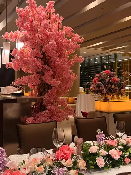 We transformed a restaurant space with beautiful pink floral arrangements, including a stunning cherry blossom tree centerpiece and lush table runners, creating a soft and romantic dining experience.