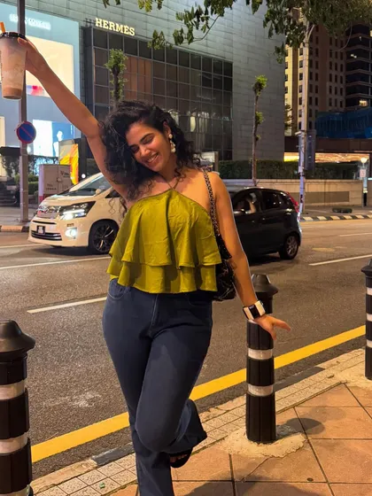 Making questionable decisions in a great outfit. Exploring Kuala Lumpur at night in a tiered olive green top and flare jeans. I can help you style looks that transition perfectly from day to night.