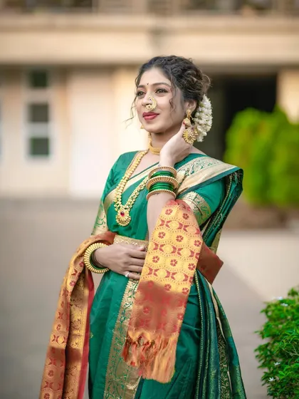 Another angle of the green Nauvari look, showing how the drape looks from the side. The placement of the pallu and the neatness of the pleats are key to this style.