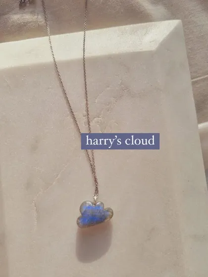 This is "Harry's cloud," my 'megh' cloud pendant carved from labradorite. I call it the stone of magic because it possesses powerful vibrations and is excellent for meditation.