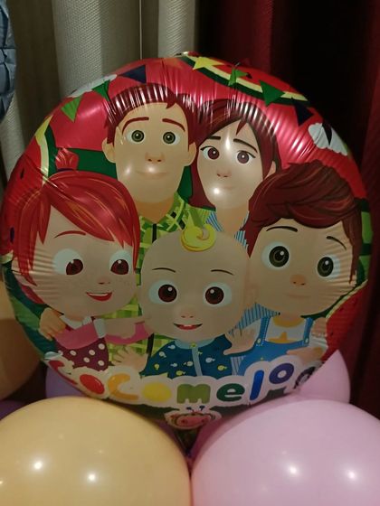 A foil balloon featuring the whole Cocomelon family.