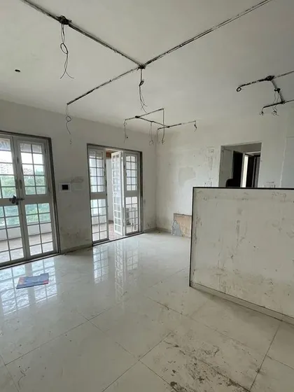 Before: An empty living area with plain walls and basic flooring. A blank canvas awaiting a story.