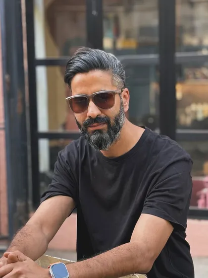 For a more relaxed look, the hair from a man bun style can be worn down. This shows the versatility of having length on top with faded sides.