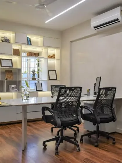 One of the director's cabins in the SAS office. A glass partition maintains a connection to the main studio, while a backlit shelving unit provides ample space for displaying books, models, and awards.